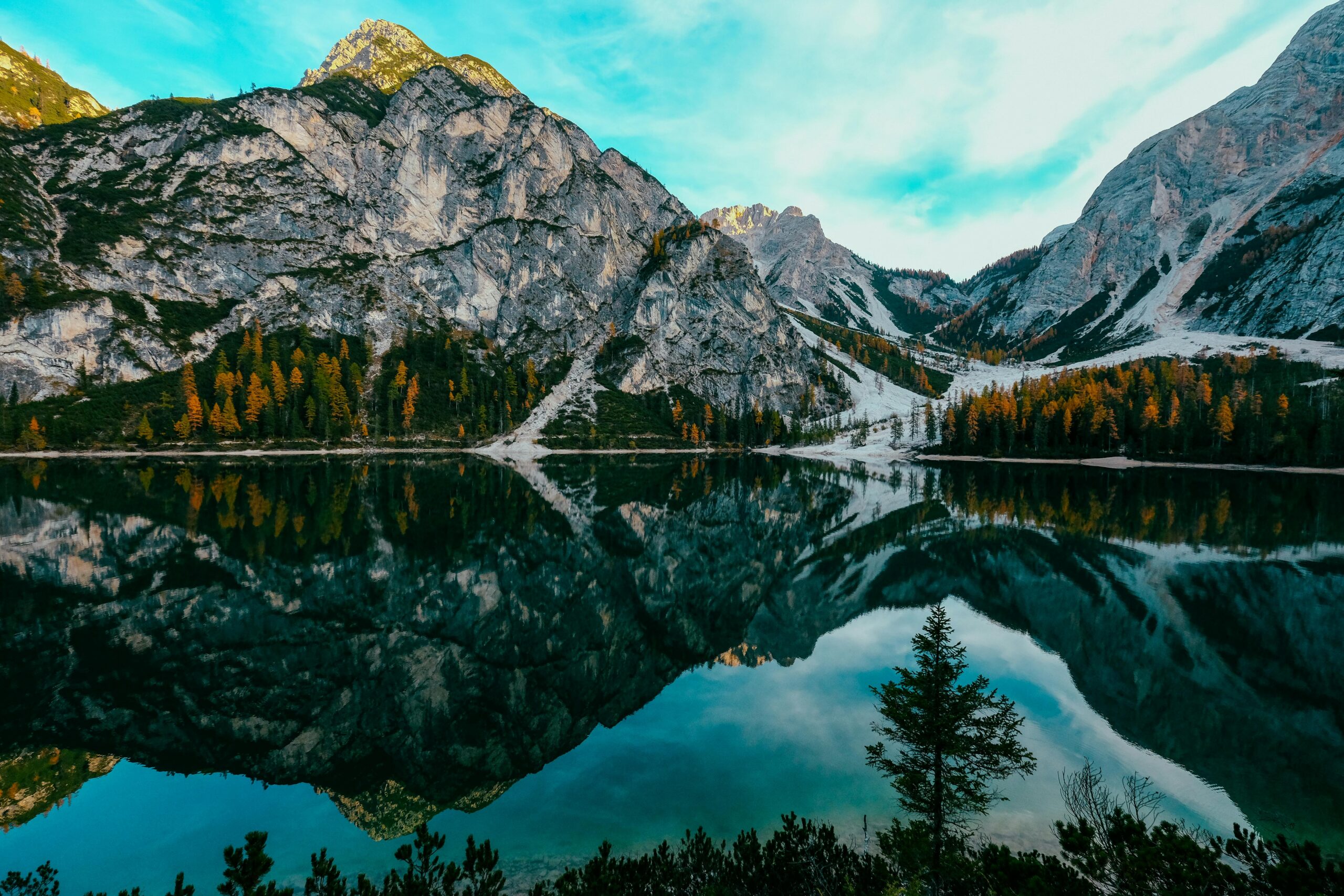 A breathtaking view of Lake Braies with mountain reflection in the Italian Alps. Ideal for nature lovers.